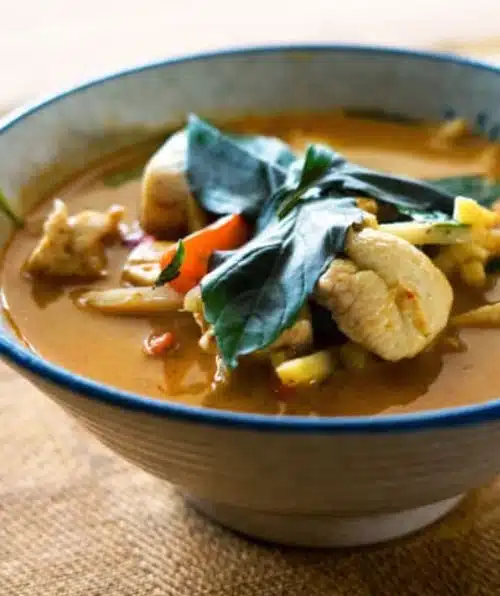 A picture of a bowl of soup with meat and vegetables