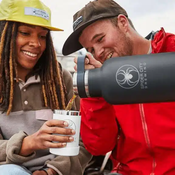 A picture of a smiling man and woman pouring a drink